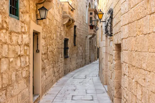 Photo of beautiful view of ancient narrow medieval street town Mdina, Malta