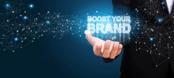Photo of Boost Your Brand in the hand of business. Boost Your Brand concept.