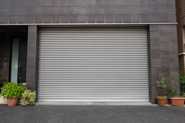 A closeup shot of automatic metal roller door used in factory, storage, garage, and industrial warehouse. The corrugated and foldable metal sheet offer space saving and provide urban and rustic feel A closeup shot of automatic metal roller door used in factory, storage, garage, and industrial warehouse. The corrugated and foldable metal sheet offer space saving and provide urban and rustic feel shutter door stock pictures, royalty-free photos & images