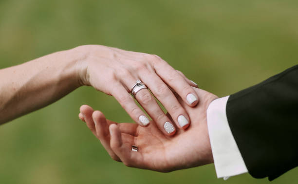 istock women's and men's hands wedding rings 1029813956