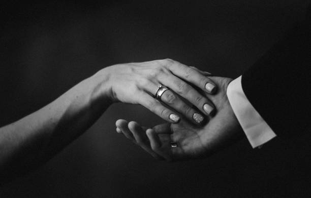 istock women's men's hands with wedding rings 1029813966