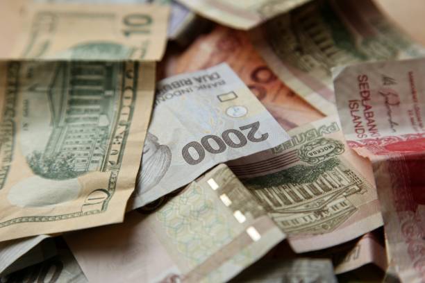 istock Different currencies from around the world.  This image can be used to represent the concept of foreign exchange or global money. 1029814872