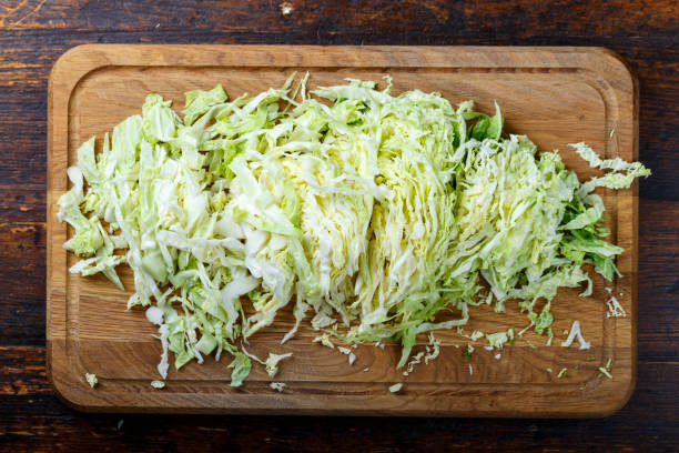 chopped Pekinese cabbage on a wooden background.
