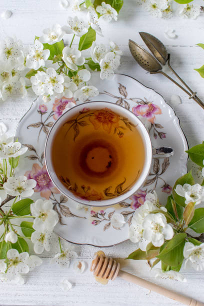 istock cup of tea in fine china surrounded by white spring flower blossoms 1029822414