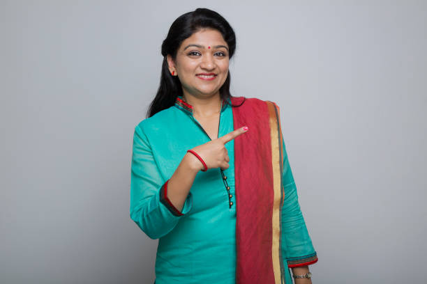 istock Smiling young woman showing blank copy space - Stock image 1029822636