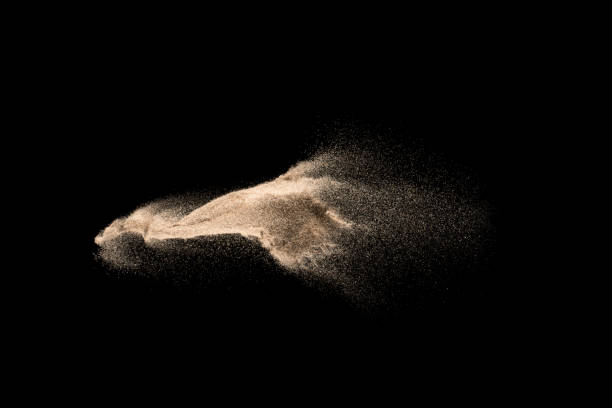 istock Dry river sand explosion. Golden colored sand splash agianst dark background. 1029822994