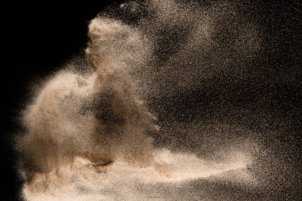 istock Dry river sand explosion. Golden colored sand splash agianst dark background. 1029823152