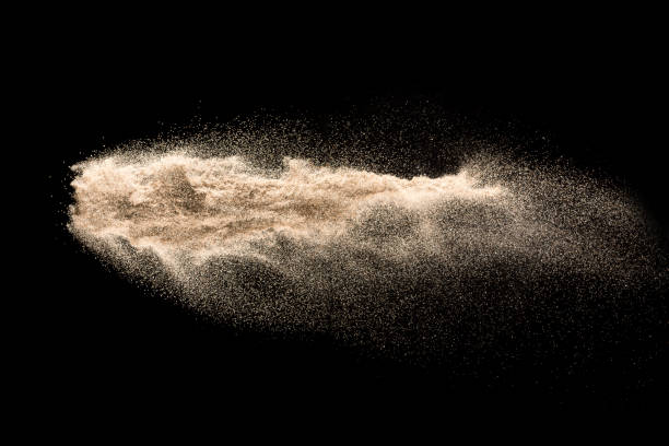 istock Dry river sand explosion. Golden colored sand splash agianst dark background. 1029823314
