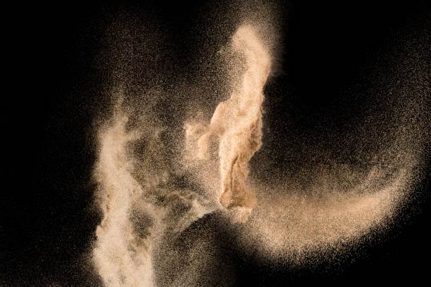 istock Dry river sand explosion. Golden colored sand splash agianst dark background. 1029824778