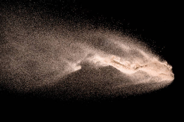istock Dry river sand explosion. Golden colored sand splash agianst dark background. 1029825128
