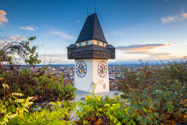 graz clock tower at sunset, graz, styria, austria - graz austria clock tower styria imagens e fotografias de stock