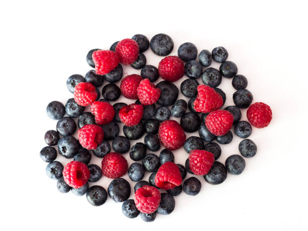 istock Blueberries and raspberries on white background. 1029831272