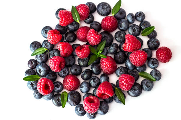 istock Blueberries and raspberries on white background. 1029831318