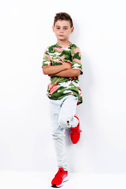 istock stylish cute boy posing as fashion model 1029831448