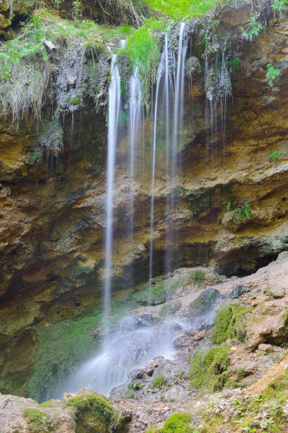 istock waterfall on a rocky cliff in a green forest 1029834022