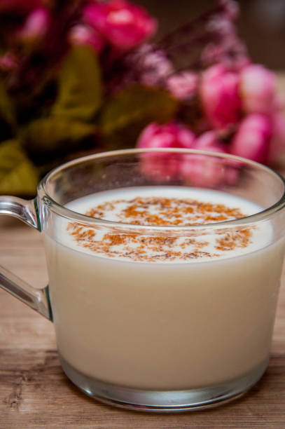 istock Milk and cinnamon - roses on a wooden background 1029845772