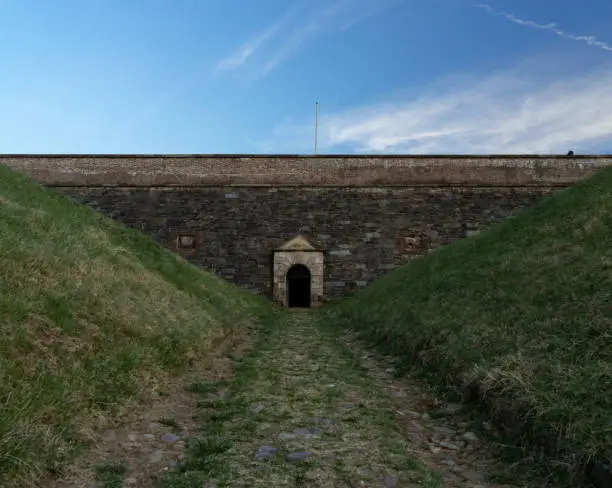 A grassy embankment surrounds the small side entrance to a historic Civil War fortress near Washington, D.C.