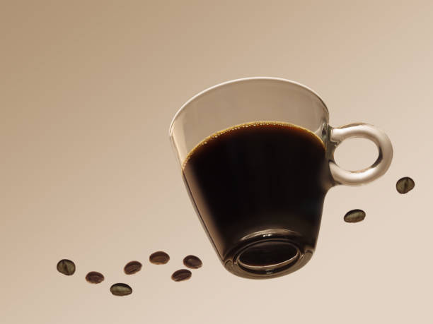 Black espresso coffee in a clear, transparent cup with beans. Seen from below.