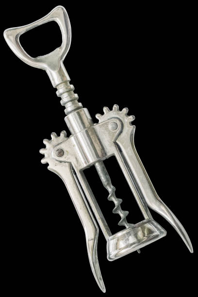 Old Chrome Plated Wing Corkscrew Isolated On Black Background Studio shot of old chrome plated wing corkscrew reverse side, isolated on black background. cork puller stock pictures, royalty-free photos & images