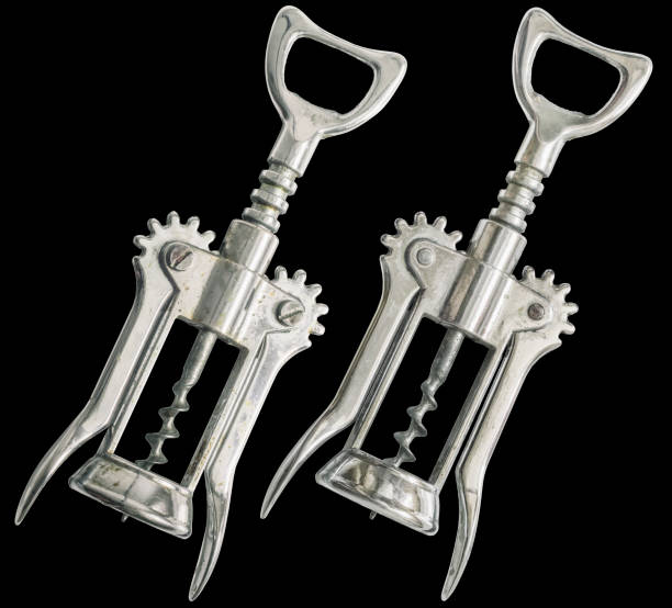 Old Chrome Plated Wing Corkscrew Front And Reverse Side Isolated On Black Background Studio shot of old chrome plated wing corkscrew, front and reverse side, isolated on black background. cork puller stock pictures, royalty-free photos & images