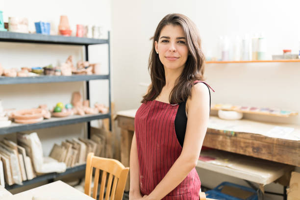 istock Confident Female Artisan Wearing Apron In Pottery Studio 1029856330