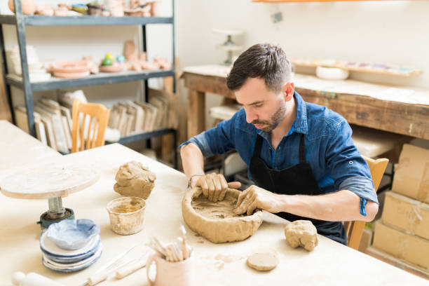 istock Owner Making Art Product From Clay In Pottery Workshop 1029862010