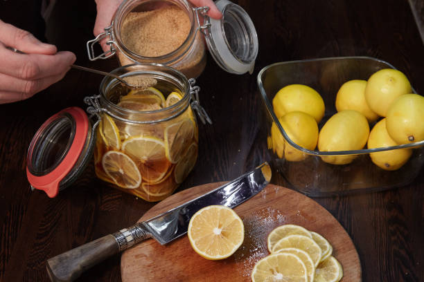 istock The man cuts lemons for preservation 1029865264