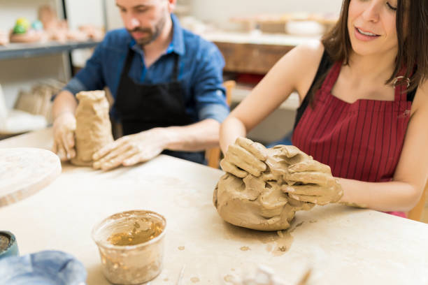 istock Woman And Man Preparing Clay To Make Pottery In Workshop 1029865530