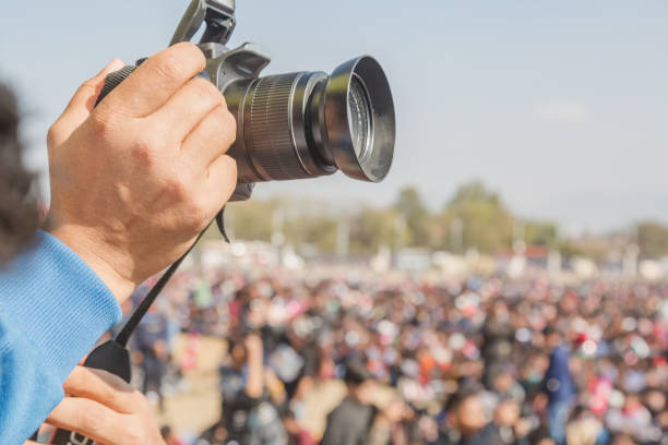 istock Camera Man Taking Photos with Digital DSLR Camera 1029867206