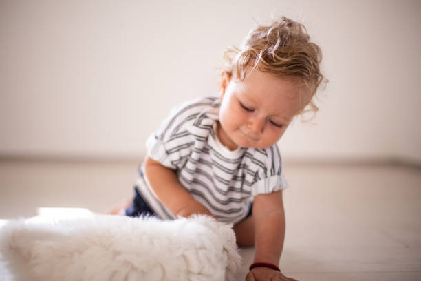 istock Baby play with the dog 1029873408