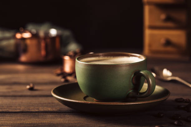 istock Green cup of coffee with coffee grinder 1029874894