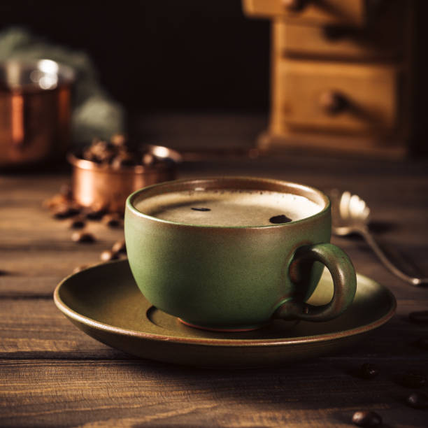 istock Green cup of coffee with coffee grinder 1029874906