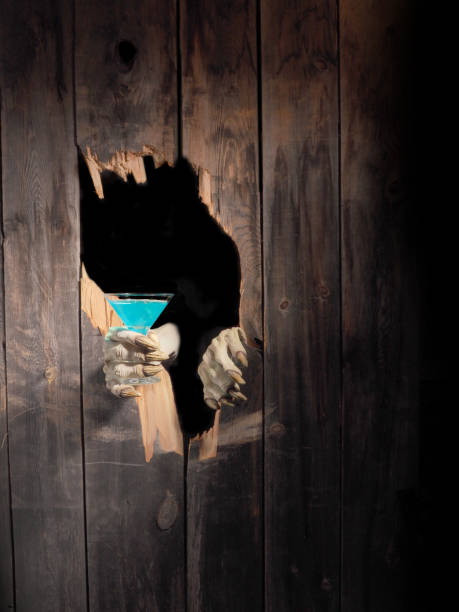 istock Zombie hand through hole cracked in rustic wood.Halloween theme 1029888782