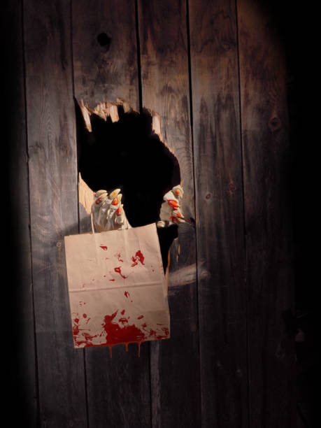istock Zombie hand through hole cracked in rustic wood.Halloween theme 1029892174
