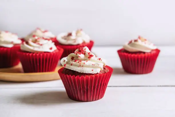 Photo of Red velvet cupcake on white wooden table