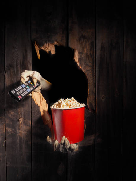 istock Zombie hand through hole cracked in rustic wood.Halloween theme 1029892768