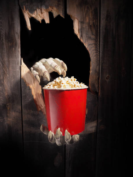 istock Zombie hand through hole cracked in rustic wood.Halloween theme 1029892784