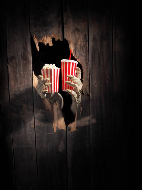Zombie hand through hole cracked in rustic wood.Halloween theme