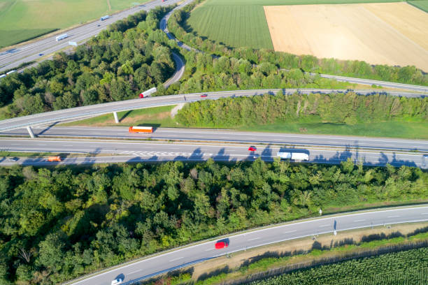 istock Aerial view of highway intersection with trucks 1029895380