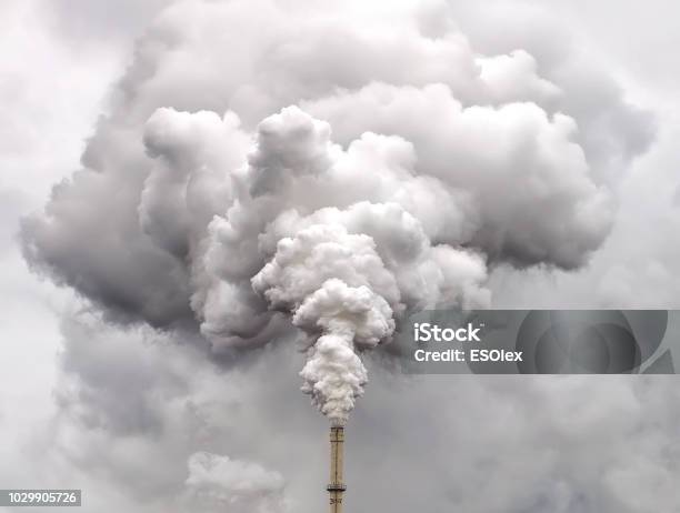 Smoke From Factory Pipe Against Dark Overcast Sky Stock Photo - Download Image Now - Pollution, Smoke - Physical Structure, Fumes