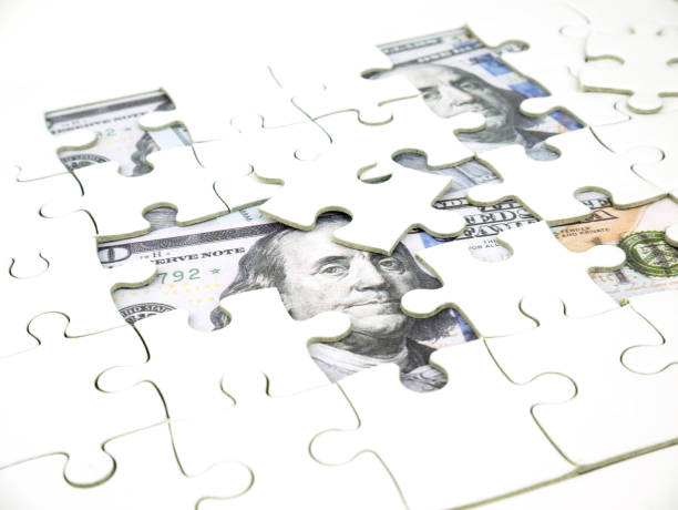istock Missing jigsaw puzzle pieces on 100 Dollar money background, Key for Business solution success concept. 1029906600
