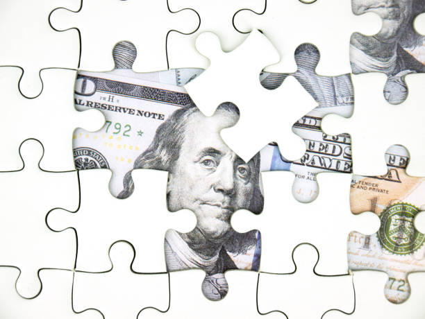 istock Missing jigsaw puzzle pieces on 100 Dollar money background, Key for Business solution success concept. 1029908382