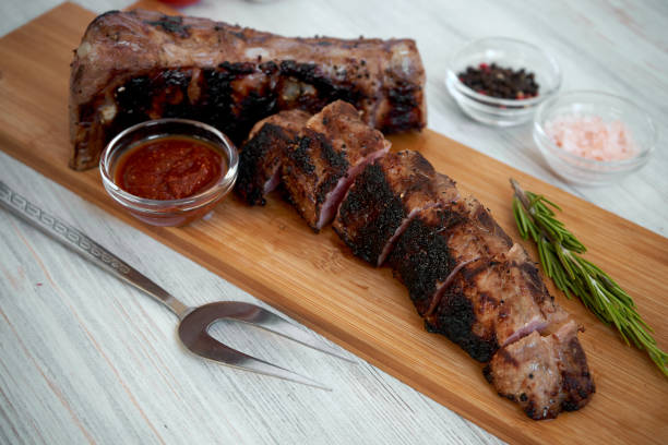istock Grilled sliced barbecue pork ribs on a cutting board 1029908712