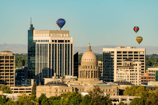 istock Red white and Blue hot air balloon over state capitol building 1029908752
