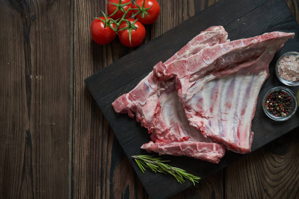 istock Pork ribs on the dark wooden backgound 1029909090