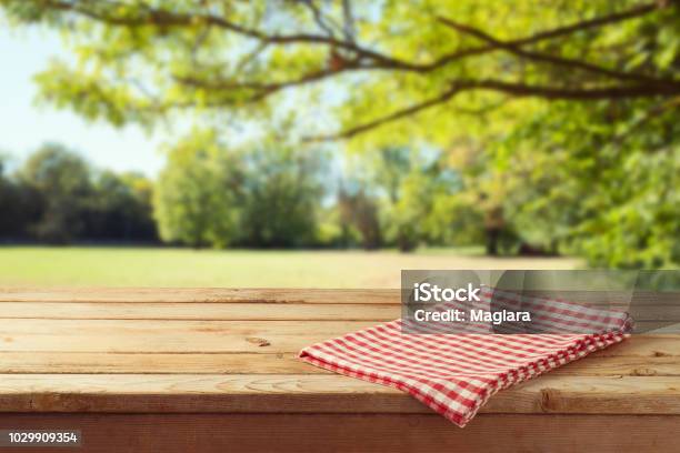 Empty Wooden Table With Tablecloth Over Autumn Nature Park Background Stock Photo - Download Image Now