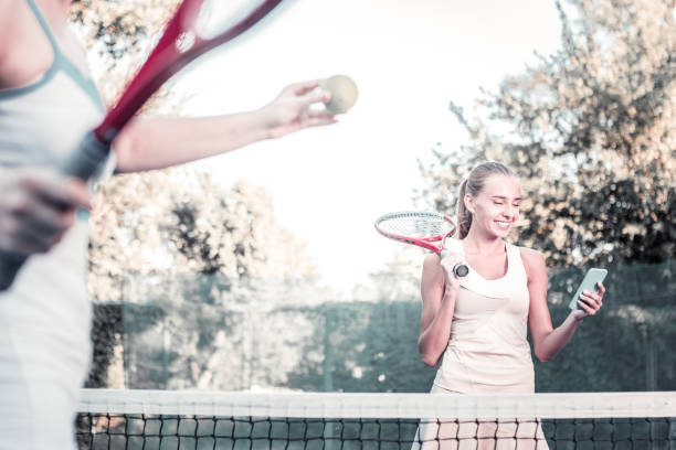 istock Cheerful glad female player distracting from game 1029912760