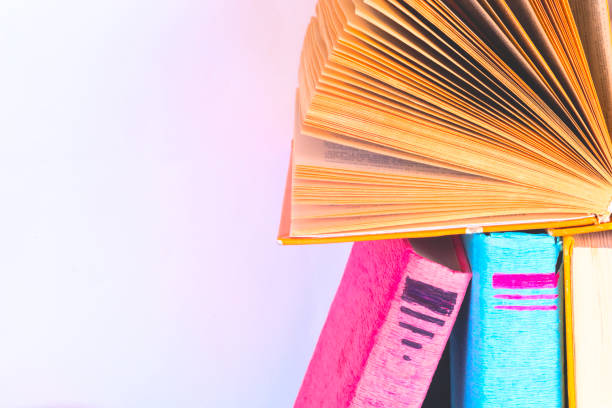 istock Open book, hardback books on bright colorful background. 1029915462