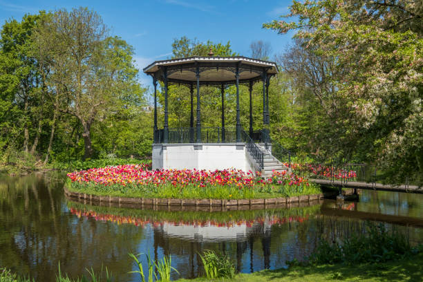 bridge with beautiful  park kiosk and tulips in Vondelpark in Amsterdam, Netherlands