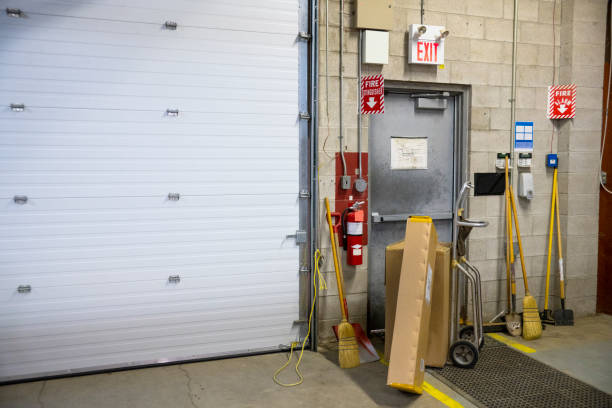 A blocked fire exit door in a warehouse A blocked fire exit door in an industrial building such as a warehouse or factory.  Blocked fire exits are very dangerous and they are in violation of safety regulations. covering stock pictures, royalty-free photos & images